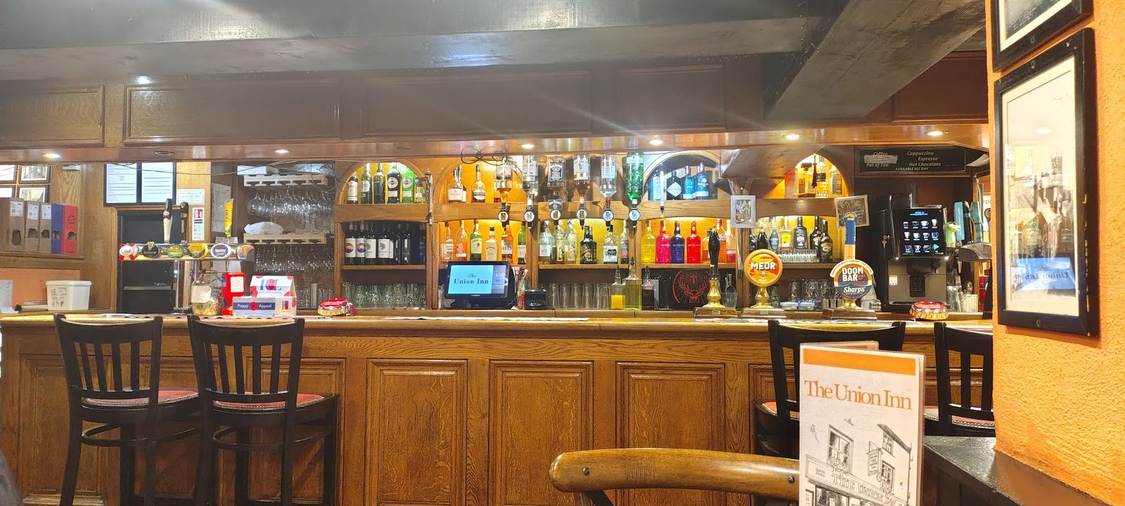 The bar at The Union Inn — wood panelling and a proper line of pumps