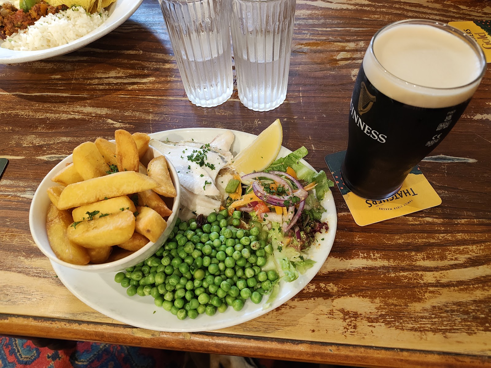 Locally sourced fish with chips and a pint of stout